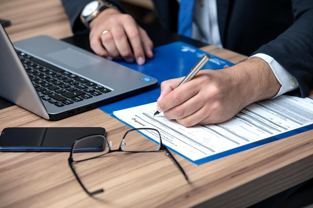 Business continuity documents and risk assessment forms on a desk